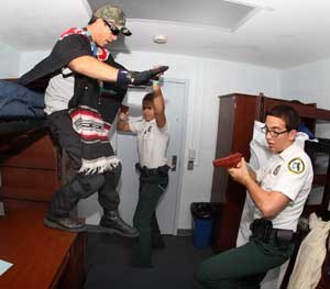 Broward County, Fla., Sherriff's Department police Explorers Kyle Wuensch, right, and Jeffery Aylor arrest a mock drug dealer played by DEA Special Agent Greg Peckingpugh as they participate in a search and arrest scenario at the Law Enforcement Explorers Conference Thursday July 22, 2010 in Atlanta. The program's best gathered in Atlanta for the conference, which is partly a recruitment tool the help ready the next generation of law enforcement officers.