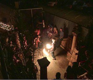 This photo provided by David Coons shows a fire dance performance in an underground music club known as known as Purple 33 in a neighborhood of Los Angeles. (David Coons via AP)