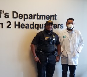Pictured are Deputy Deandre Jennings following his test, and Mr. Kevin Bland, project director of Rapid Reliable Testing.