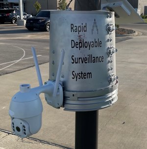 The system is hinged open and slapped around a smooth utility pole, flagpole, tree or other cylindrical vertical structure.