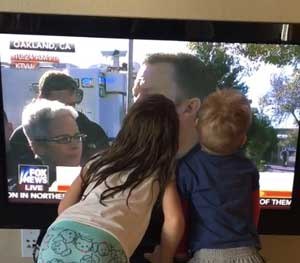 Standing beside Oakland PIO Johnna Watson, Sergeant Ray Kelly of the Alameda County Sheriff’s Office answers reporters' questions following the Ghost Ship warehouse fire. Kelly's kids, upon seeing their dad on the TV, race to kiss the screen.