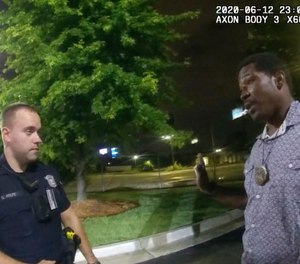 This screen grab taken from body camera video provided by the Atlanta Police Department shows Rayshard Brooks, right, as he speaks with Officer Garrett Rolfe.