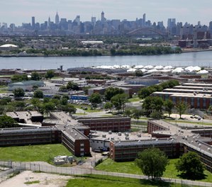This June 20, 2014 file photo shows the Rikers Island jail complex in New York with the Manhattan skyline in the background. (AP Photo/Seth Wenig, File)