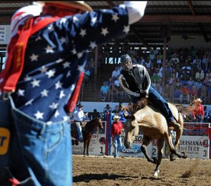 Inmates participating in the rodeo all wear helmets, protective vests and a mouth piece.