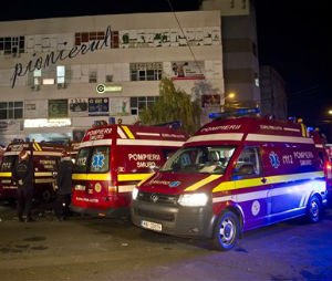 Ambulances outside the site of a fire that occurred in a nightclub in where a heavy metal band's pyrotechnical show sparked a deadly. (AP Photo/Vadim Ghirda)
