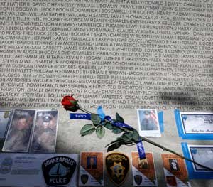 A rose is placed at the wall with the names of fallen police officers at the National Law Enforcement Officers Memorial in Washington during the National Police Week.