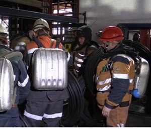 This Feb. 26 photo provided by Russian Emergency Situations Ministry press service shows rescuers getting on an elevator in Vorkuta, Russia. (Ministry of Emergency Situations press service via AP)