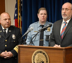 St. Paul Police Chief Todd Axtell, left, and Minneapolis Interim Police Chief Amelia Huffman listen as U.S. Attorney Andrew Luger, right, speaks in Minneapolis on Tuesday, May 3, 2022.