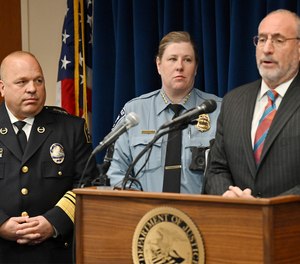 St. Paul Police Chief Todd Axtell, left, and Minneapolis Interim Police Chief Amelia Huffman listen as U.S. Attorney Andrew Luger, right, speaks in Minneapolis on Tuesday, May 3, 2022.