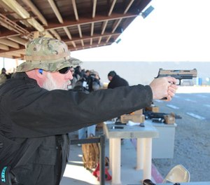Doug Wyllie gets a good look at the sight picture presented by the VTAC high-visibility sights mounted atop the new SIG VTAC P320 pistol. (Photo/Gene Whisenand, www.tridentfirearms.com)
