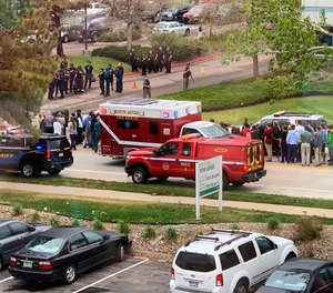 Police officers and students are seen outside STEM School Highlands Ranch, a charter middle school in the Denver suburb of Highlands Ranch, Colo. (Courtney Harper via AP, File)
