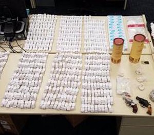 Police seized 350 grams of raw heroin and two handguns.
