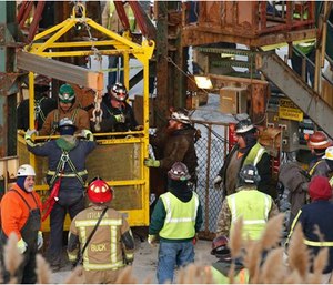The fourth group of workers emerge from an elevator after they were stuck overnight in a shaft at the Cayuga Salt Mine in Lansing, N.Y. Cargill Inc. (Simon Wheeler/The Ithaca Journal via AP, Pool)