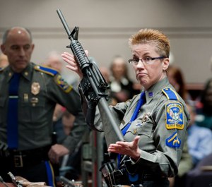 Detective Barbara J. Mattson, of the Connecticut State Police, holds a Bushmaster AR-15 rifle, the same make and model used by Adam Lanza in the 2012 Sandy Hook School shooting (AP Photo/Jessica Hill, File)