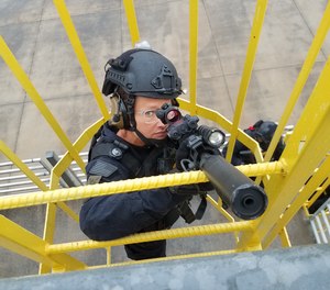 Deputy Sarah Merriman, a member of RCSD’s Special Response Team climbs to the top of a building during tactical training at the S.C. Fire Academy.
