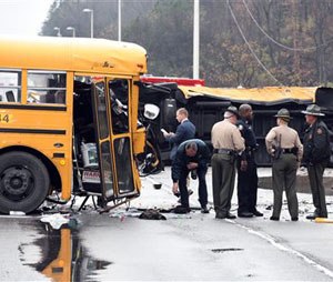 Authorities work the scene of an accident involving two school buses in Knoxville, Tenn., Tuesday, Dec. 2, 2014. Knoxville Police Department spokesman Darrell DeBusk said “several students have been injured and are in the process of being transported to the hospital.”