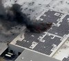 Video: Crews work rooftop fire involving massive section of solar panels