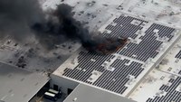 Video: Crews work rooftop fire involving massive section of solar panels