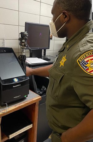 An East Baton Rough Sheriff’s Deputy processes an arrestee DNA profile using the RapidHIT ID system. (Image/East Baton Rouge Sheriff’s Office)