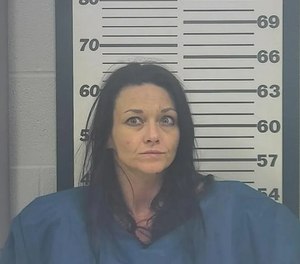 Lacy Perry allegedly lunged at an officer’s gun after jumping behind the wheel of a police car before shooting.