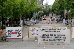 A sign on the street welcomes visitors and a list of demands is posted Wednesday, June 24, 2020, inside the CHOP (Capitol Hill Occupied Protest) zone in Seattle. Image: AP Photo/Ted S. Warren
