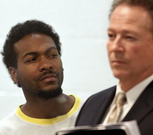 Trenton Trevon Lovell, 27, left, the suspect in the shooting death of L.A. County sheriff's deputy Steve Owen, with public defender John Henderson, during his arraignment in Lancaster.