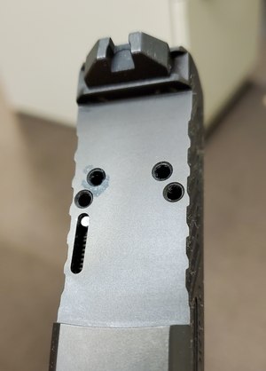 Shadow Systems optics mounting plate. The four threaded holes allow for various optics from a number of makers.