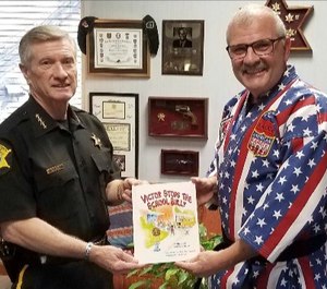 Richland County Sheriff Leon Lott receives a copy of