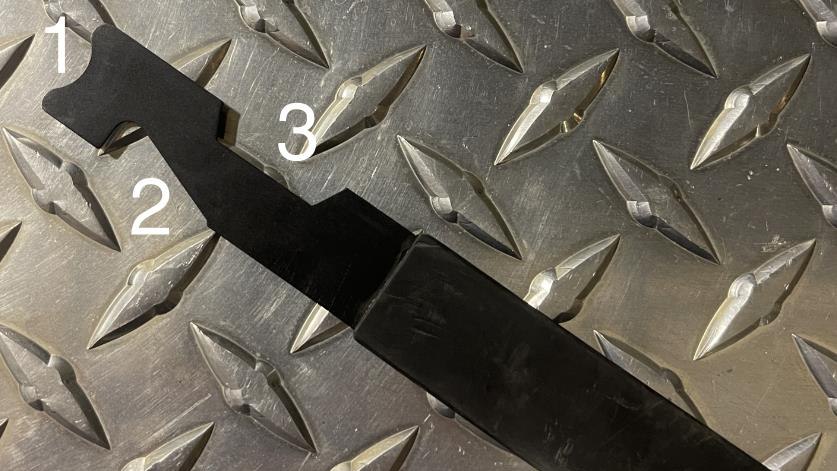 Figure 1: The halfmoon cutout (1) is used for inward-swinging doors, the “J” notch (2) is used for outward swinging doors, and the trapezoid cutout (3) is for obsolete car door locks.