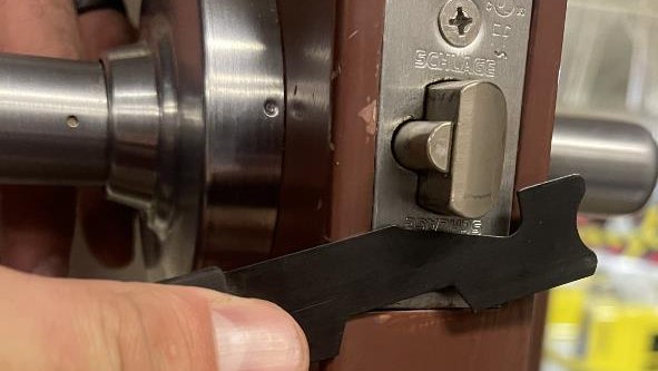 Figure 2: The “J” style cutout will slip around the latch and allow you to push the latch into the door as you press the tool inward and pull it toward you.