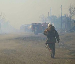 In this undated photo taken from the Website of the Ministry for Emergency Situations, Khakassia branch, a firefighter extinguishes the fire in Khakassia, a region in southeastern Siberia, Russia. (Ministry for Emergency Situations, Khakassia branch in Siberia via AP)