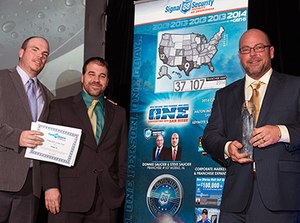 Former sheriff’s deputy Donnie Saucier, right, says running a security franchise is very similar to running a small law enforcement agency. Above, he joins his brother and co-owner, Steve Saucier, and general manager, Justin Farmer, in celebrating their award for Signal 88 Franchise of the Year 2015.