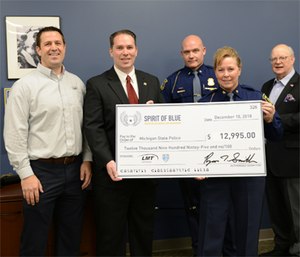 The Spirit of Blue presented the Michigan State Police with five tactical rifles valued at $12,955. Presenting the grant (left to right) were Mathew Pruitt, LMT Director of Sales & Marketing; Ryan T. Smith, Executive Director and Gary Blair, Board Chairman of Spirit of Blue. Receiving the grant (left to right) were Lt. David Sosinski, Emergency Support Team Leader and Col. Kriste Kibbey Etue, Director of the Michigan State Police.