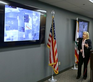 Sacramento County District Attorney Anne Marie Schubert displays a video from a Sacramento County Sheriff's helicopter in last year's fatal shooting of an unarmed black man, during a news conference in Sacramento, Calif., Saturday, March 2, 2019. (AP Photo/Rich Pedroncelli)