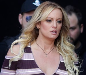 Adult film actress Stormy Daniels arrives for the opening of the adult entertainment fair "Venus" in Berlin. Daniels has sued the Columbus police department for $2 million over her arrest at a strip club last summer. The federal defamation lawsuit filed Monday, Jan. 14, 2019, alleges officers conspired to retaliate against Daniels for her sex allegations concerning Donald Trump before he became president. (AP Photo/Markus Schreiber, File)