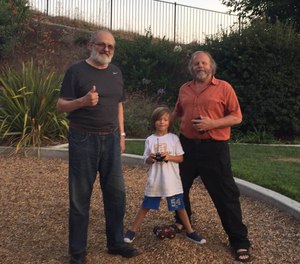 Mike Taigman, his son Ax, and Jack Stout at a park near Stout's home.