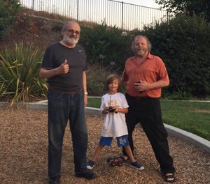 Mike Taigman, his son Ax, and Jack Stout at a park near Stout's home.