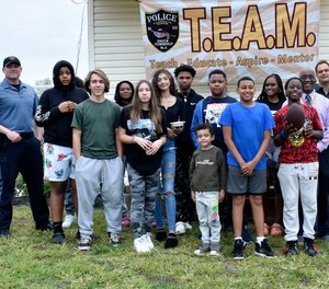 Brick Township Police officers pose with local students participating in the T.E.A.M. program.