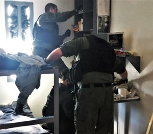 Strike Force members search a cell at Northeast Correctional Complex in Mountain City, Tenn. in March 2021. The announced search yielded a large number of drugs, weapons and other contraband.