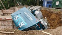 Cement truck rolls over into hole at Mass. construction site