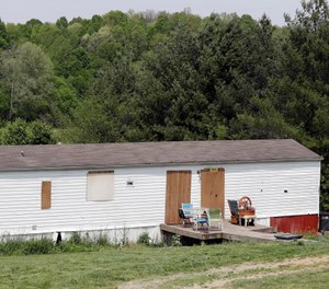 The home where six people were found killed Saturday, April 27, has its doors and windows covered Tuesday, April 30, 2019, in Westmoreland, Tenn. (AP Photo/Mark Humphrey)