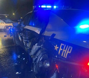 The trooper had activated his emergency lights and was on the way to the disabled vehicle when the Tesla hit the cruiser's left side.