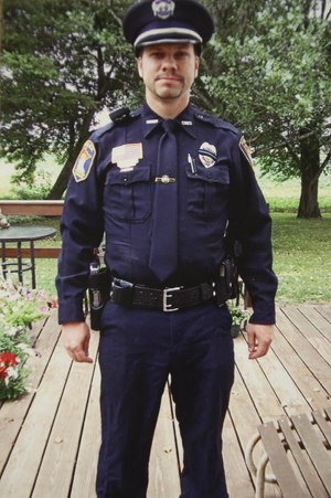 This photo was taken by Tom’s mother, Rosella Decker. Tom had just finished working all night, then got dressed for the funeral of a fellow officer. Rosella requested her son get some sleep. She said it would be too hard to stand at attention so long at the funeral of an officer after working all night. Tom’s response was, “They’d do it for me.” Rosella said, “Little did I know that a few months later the funeral would be for him, and he was right. They did do it for him.”