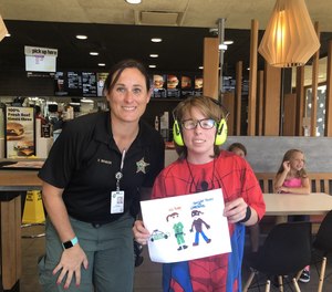 The author is pictured here with Jen, who is on the autism spectrum and uses earmuffs to reduce noise overstimulation.