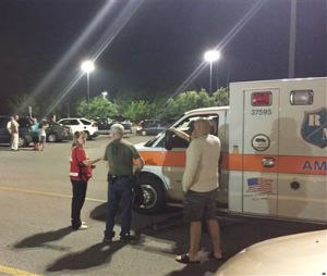 Emergency personnel stand by as evacuees gather at the Foothills Mall early July 2, 2015, in Maryville, Tenn., after they were forced to leave their homes when rail car carrying a flammable and toxic gas derailed and caught fire. (Brittany Bade/WBIR.com via AP)