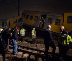 Emergency workers gather at the scene of a train collision at the Booysens train station near Johannesburg Friday July 17, 2015. A commuter train crashed into another passenger train during rush hour Friday in South Africa's largest city injuring more than 300 people, an emergency services spokeswoman said. (AP Photo/Jacques Nelles)
