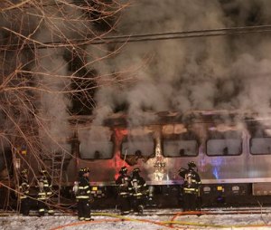 A Metro-North Railroad passenger train smolders after hitting a vehicle in Valhalla, N.Y., Tuesday, Feb. 3, 2015.