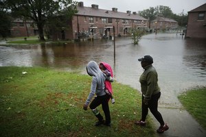 Residents survey the flooding at the Trent Court public housing complex in New Bern, North Carolina, following Hurricane Florence, September 2018. Image: Getty/Chip Somodevilla