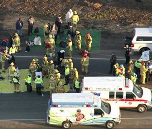 Video frame grab of passenger recieving medical aide after a Metrolink train that derailed in Oxnard early Tuesday after colliding with a vehicle on the tracks.