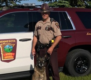 Trooper Doug Rauenhorst with K-9 Diesel on July 9, 2019. The pair worked together for over eight years.